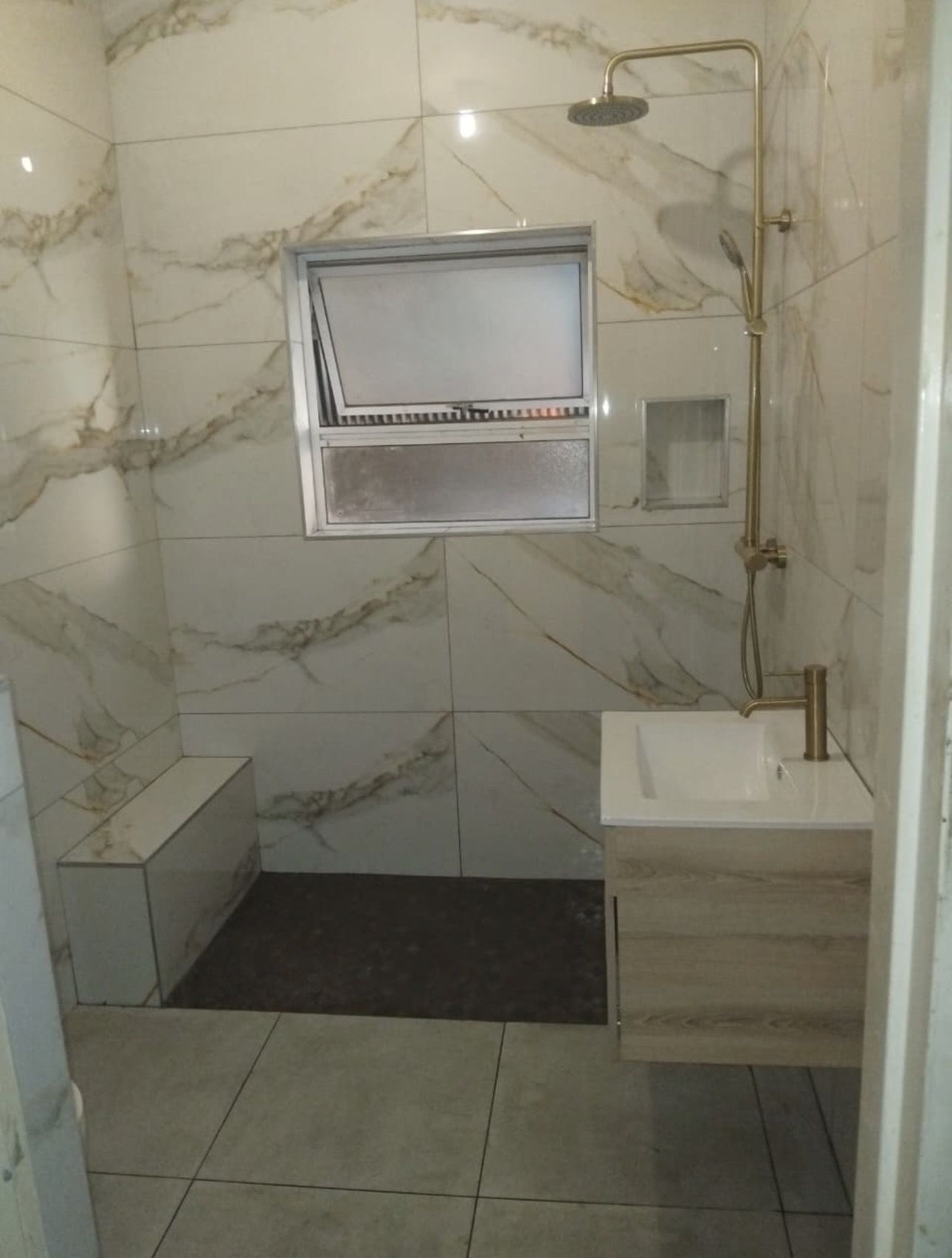 Bathroom after renovation — marble tiles and shower