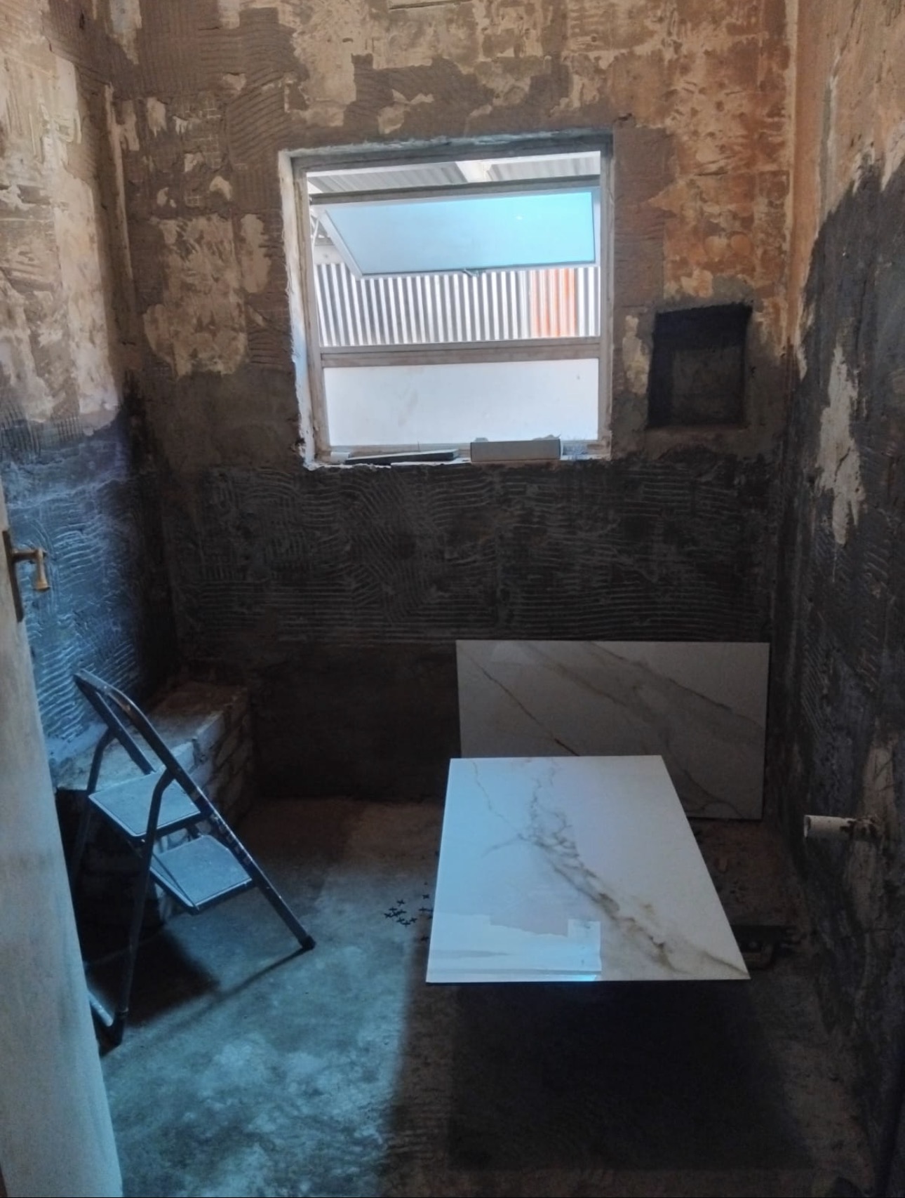 Bathroom before renovation — stripped walls