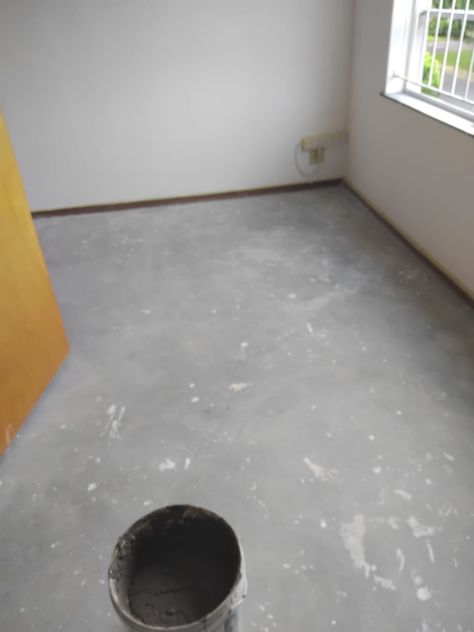 Room before tiling — bare cement floor